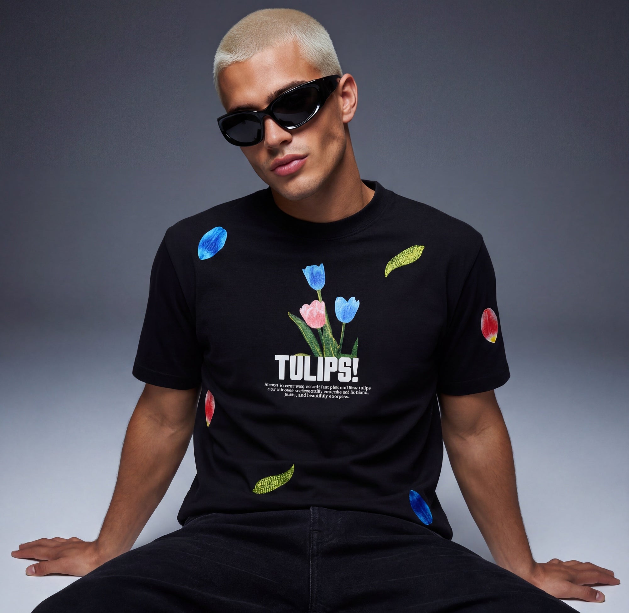 Person wearing a black t-shirt with colorful tulip design and text on a gray background